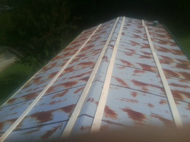 Rusted metal roof panels with new wood purlins before replacement — Storm Damage Roof Repair in Bristow by Roofing Brothers